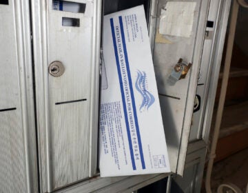 A mail ballot is positioned in a mailbox