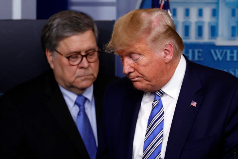 FILE - In this March 23, 2020, file photo President Donald Trump moves from the podium to allow Attorney General William Barr to speak about the coronavirus in the James Brady Briefing Room in Washington. The relationship between President Donald Trump and top ally Attorney General William Barr is fraying over the lack of splashy indictments so far in the Justice Department’s investigation into the origins of the Russia probe, according to people familiar with the matter. (AP Photo/Alex Brandon, File)