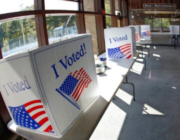 An early election ballot completion area at the North Park Ice Skating Rink Lodge area, Friday, Oct. 9, 2020, in McCandless, Pa. (AP Photo/Keith Srakocic)