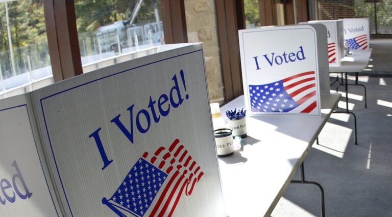 An early election ballot completion area is being prepared at a collection location