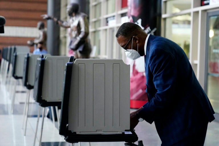 Philadelphia City Council President Darrell Clarke fills out his ballot at the opening of a satellite election office at Temple University’s Liacouras Center, Tuesday, Sept. 29, 2020, in Philadelphia. (AP Photo/Matt Slocum)