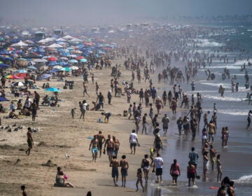 People crowd the beach in Huntington Beach, Calif., Saturday, Sept. 5, 2020. (AP Photo/Jae C. Hong)