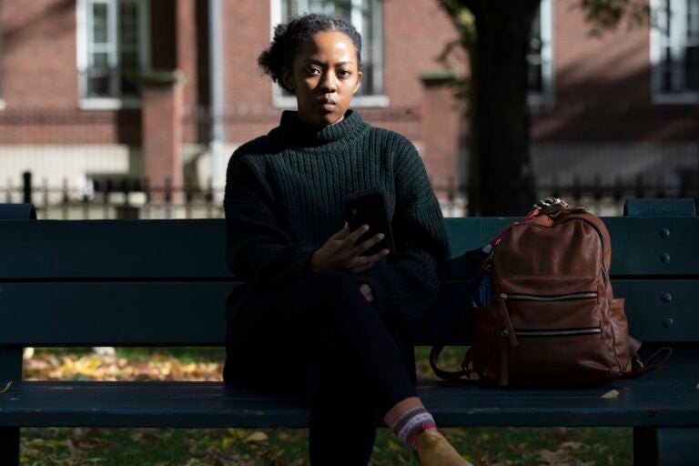 Harvard University graduate student Maya James poses in a park near the university, Wednesday, Oct. 14, 2020, in Cambridge, Mass. (AP Photo/Michael Dwyer)