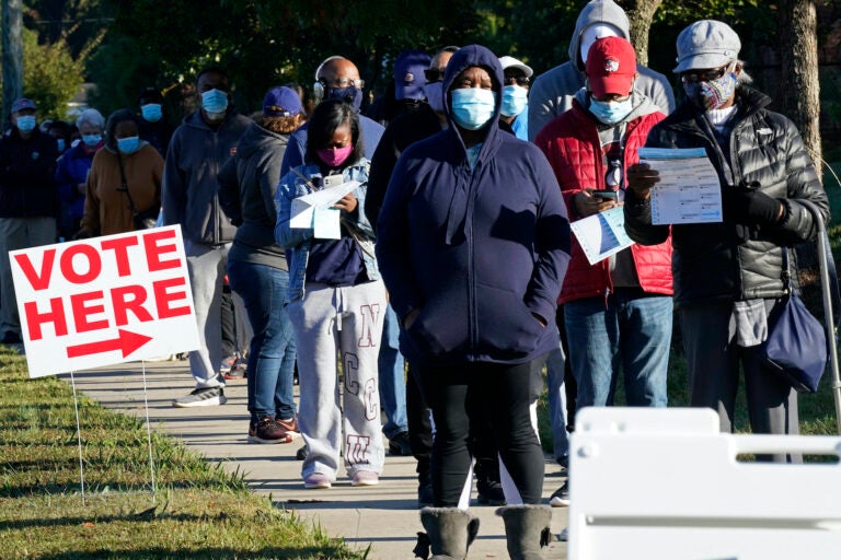 Early voters line up to cast their ballots at the South Regional Library polling location in Durham, N.C., Thursday, Oct. 15, 2020. (AP Photo/Gerry Broome)