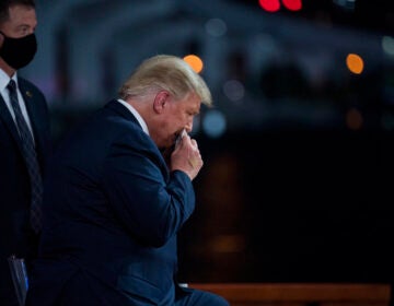 President Donald Trump wipes away sweat during an NBC News Town Hall, at Perez Art Museum Miami, Thursday, Oct. 15, 2020, in Miami. (AP Photo/Evan Vucci)