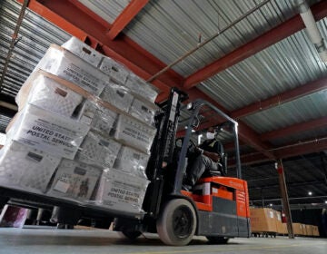 In this Sept. 3, 2020, file photo, a forklift operator loads absentee ballots for mailing at the Wake County Board of Elections as preparations for the upcoming election are ongoing in Raleigh, N.C. (AP Photo/Gerry Broome)