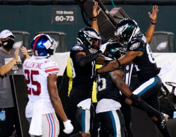 Philadelphia Eagles players celebrate after a touchdown by Boston Scott during the second half of an NFL football game against the New York Giants, Thursday, Oct. 22, 2020, in Philadelphia