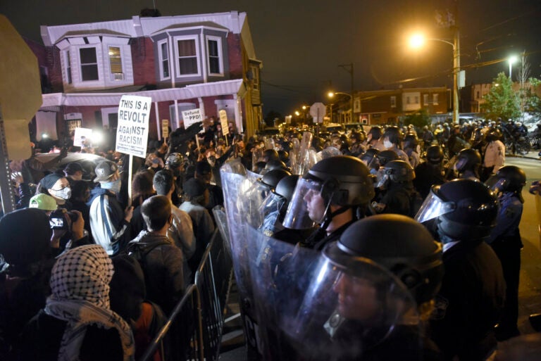 Protesters face off with police during a demonstration Tuesday, Oct. 27, 2020, in Philadelphia. Hundreds of demonstrators marched in West Philadelphia over the death of Walter Wallace Jr., a Black man who was killed by police in Philadelphia on Monday. (AP Photo/Michael Perez)