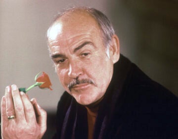 Actor Sean Connery holds a rose in his hand as he talks about his new movie 