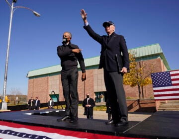 Democratic presidential candidate former Vice President Joe Biden, right, and former President Barack Obama greet each other at a rally at Northwestern High School in Flint, Mich., Saturday, Oct. 31, 2020. (AP Photo/Andrew Harnik)