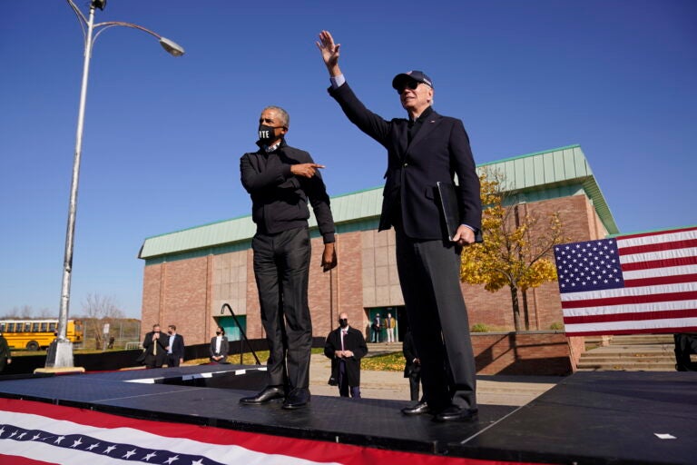 Democratic presidential candidate former Vice President Joe Biden, right, and former President Barack Obama greet each other at a rally at Northwestern High School in Flint, Mich., Saturday, Oct. 31, 2020. (AP Photo/Andrew Harnik)