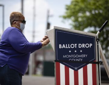 A voter drops off their mail-in ballot prior to the primary election, in Willow Grove, Pa., Wednesday, May 27, 2020. (Matt Rourke/AP Photo)