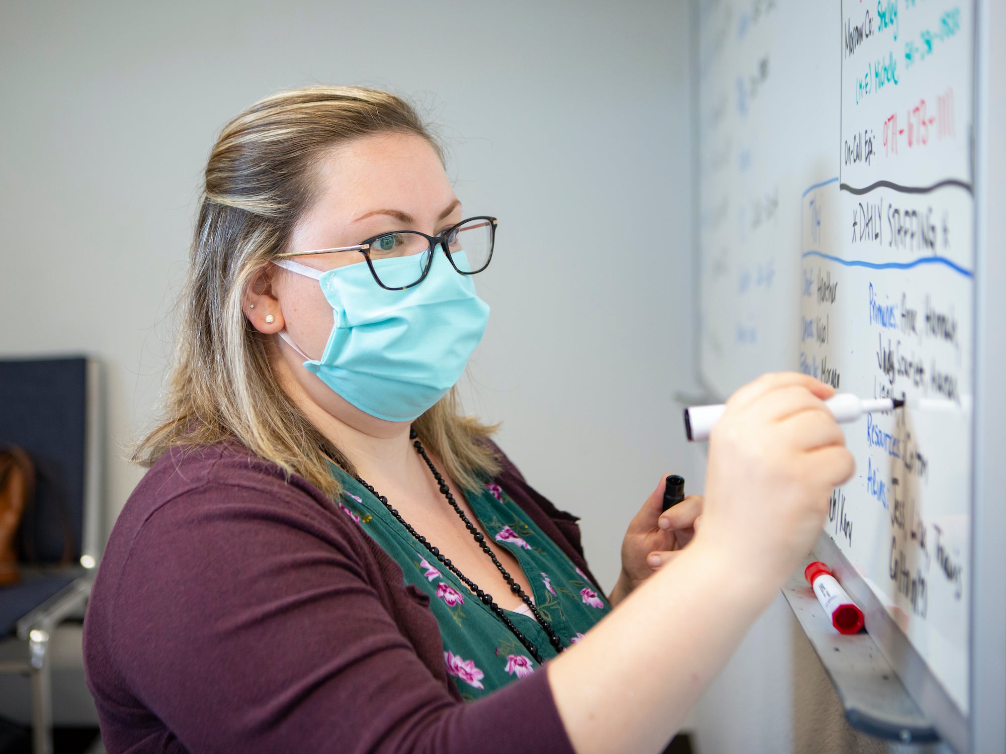 Heather Griggs, a registered nurse and operations chief of the Umatilla County Public Health Department contact tracing center in Pendleton, Ore., updates a list of job assignments on Tuesday, July 14, 2020.