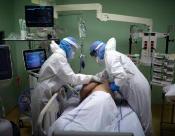 A medical crew treat a patient affected with COVID-19 in the intensive care unit at the Joseph Imbert Hospital Center