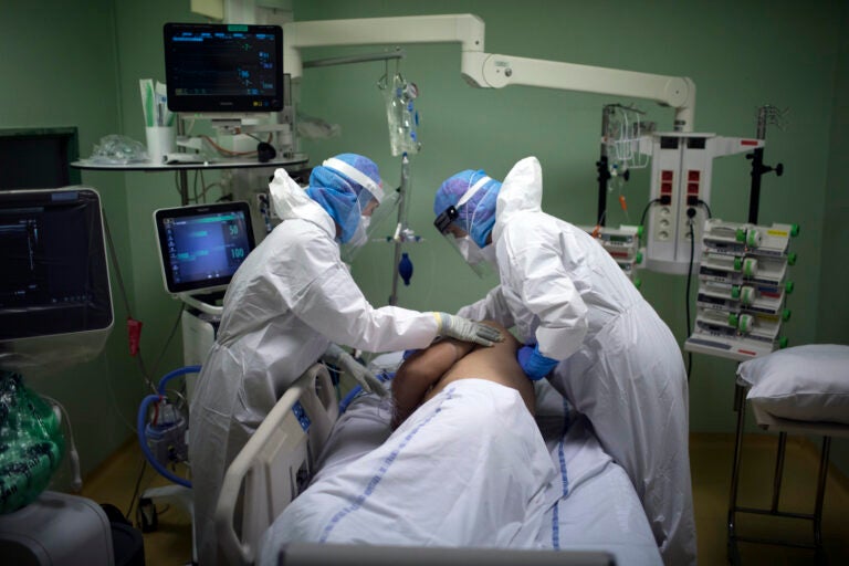 A medical crew treat a patient affected with COVID-19 in the intensive care unit at the Joseph Imbert Hospital Center