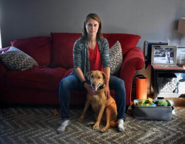 Melissa Wilhelm Szymanski sits with her dog Cooper at home in Glastonbury, Conn.