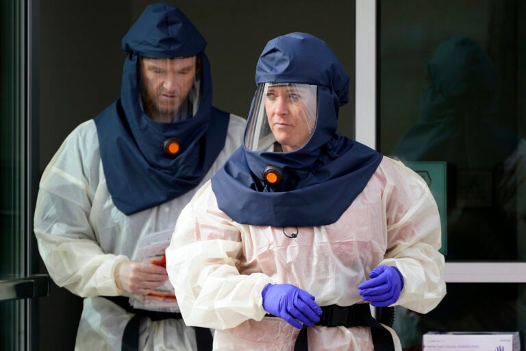 Public health nurses look on during coronavirus testing