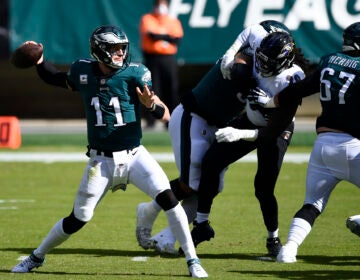Carson Wentz passes during the first half of the Eagles-Ravens game