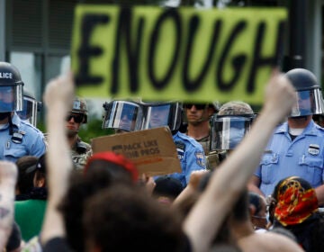 Protesters rally as Philadelphia Police officers and Pennsylvania National Guard soldiers look on in Philadelphia