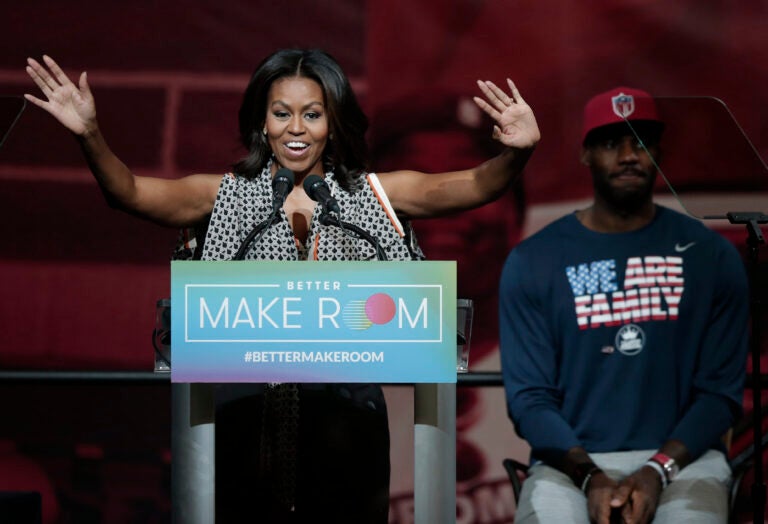 Former first lady Michelle Obama speaks at the University of Akron as NBA star LeBron James listens