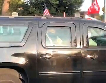 President Donald Trump drives past supporters gathered outside Walter Reed National Military Medical Center