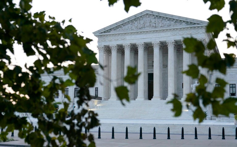 The sun rises behind the Supreme Court in Washington