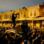 Protesters confront police during a march Tuesday, Oct. 27 in West Philadelphia.