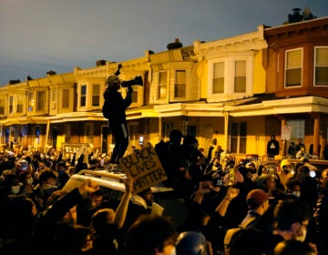 Protesters confront police during a march Tuesday, Oct. 27 in West Philadelphia.