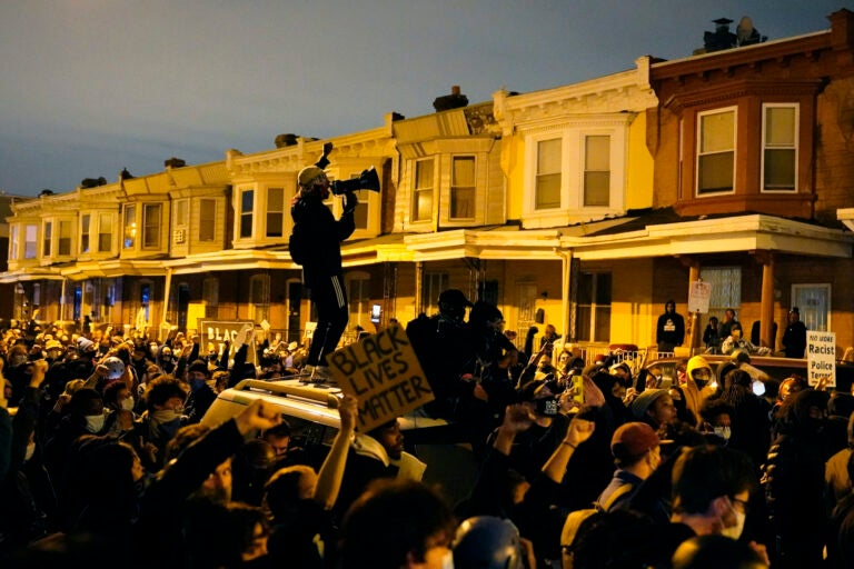 Protesters confront police during a march Tuesday, Oct. 27 in West Philadelphia.