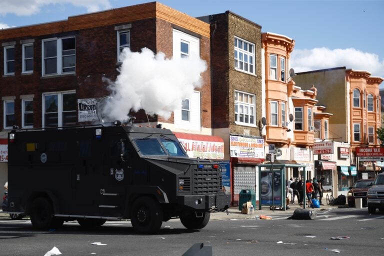 Police deploy tear gas to disperse a crowd during a protest Sunday, May 31, 2020, in Philadelphia over the death of George Floyd. Floyd died May 25 after he was pinned at the neck by a Minneapolis police officer. (AP Photo/Matt Rourke)