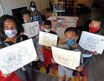 Art students led by Marcy Morris display drawings with a 