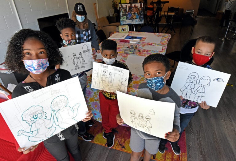 Art students led by Marcy Morris display drawings with a 