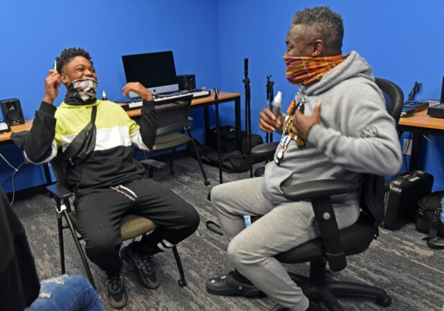 Arthur Leo Taylor makes student Ison Keith, 14, laugh during drama class