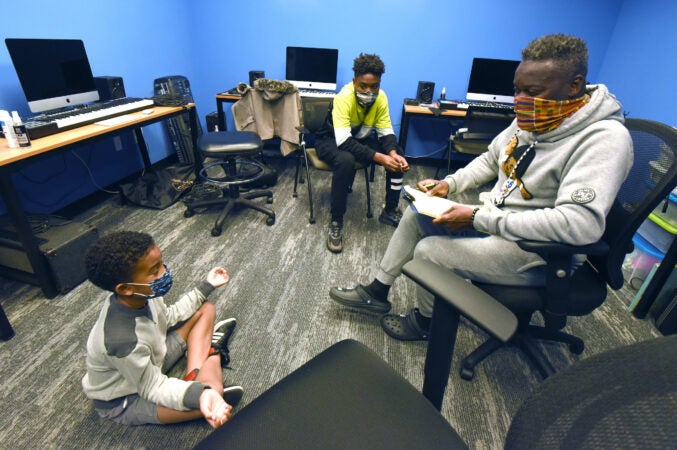 Drama teacher Arthur Leo Taylor works with students Nash Daniels, 8 (left) and Ison Keith, 14