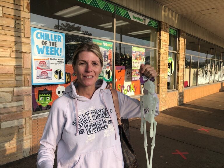 Woman holding a toy skeleton