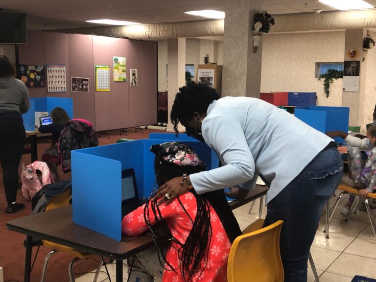 A Leap of Faith owner Melanie Thomas-Price works with fifth-grader Cameryn Jones. (Cris Barrish/WHYY)