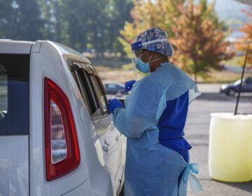 A staff member of AMI Healthcare administered a COVID-19 test at the pop-up site at the Nittany Mall in State College on Friday, Sept. 25. (Min Xian/WPSU)