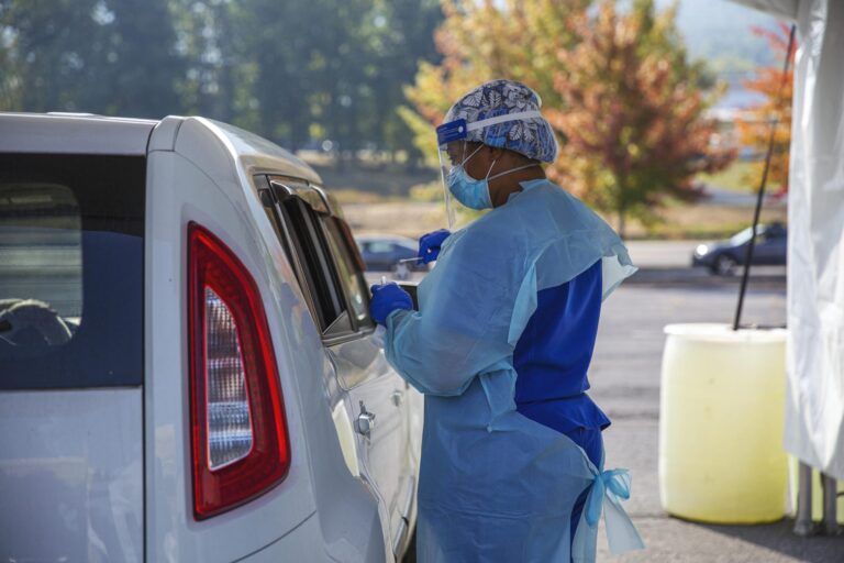 A staff member of AMI Healthcare administered a COVID-19 test at the pop-up site at the Nittany Mall in State College on Friday, Sept. 25. (Min Xian/WPSU)