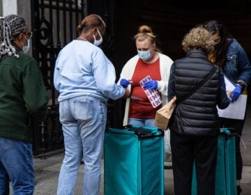 Voters exchange ballots for “I Voted Today” stickers at City Hall in Philadelphia. (Kimberly Paynter/WHYY)