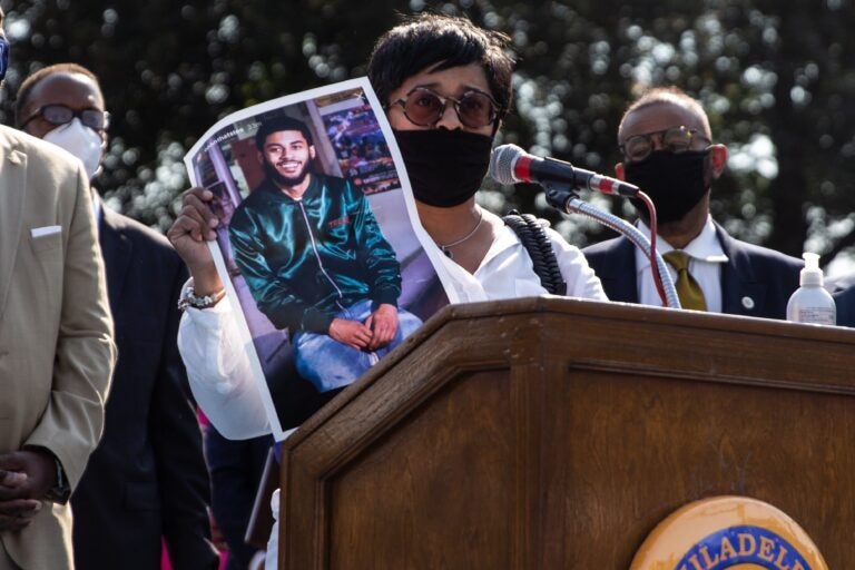 Tamika Morales holds a photo of her son, Ahmad, who was killed July, 2020, in South Philadelphia. (Kimberly Paynter/WHYY)