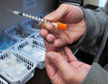 File photo: March 24, 2016, a nurse holds one of the syringes provided to intravenous drug users taking part in a state-approved needle exchange program in Connersville, Indiana. (AP Photo/Rick Callahan)