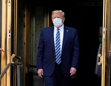 President Trump walks out of Walter Reed National Military Medical Center Monday.