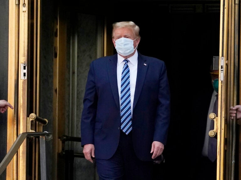 President Trump walks out of Walter Reed National Military Medical Center Monday.