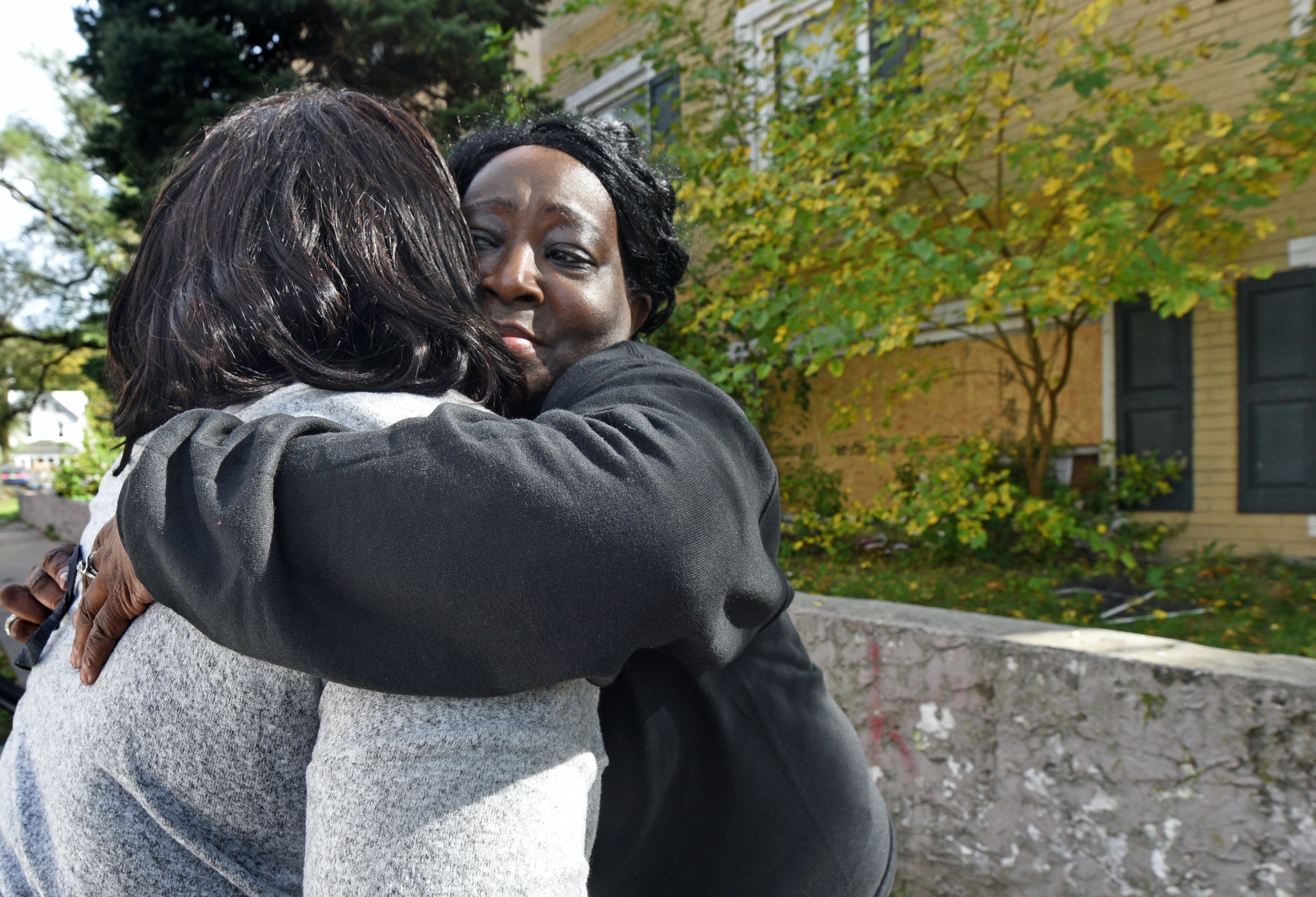 At the Cra-West Apartments in Camden on Oct. 27, tenant Pamela Mumford gets a hug after removing belongings from the apartment she shared with her daughter before the fire on Sunday