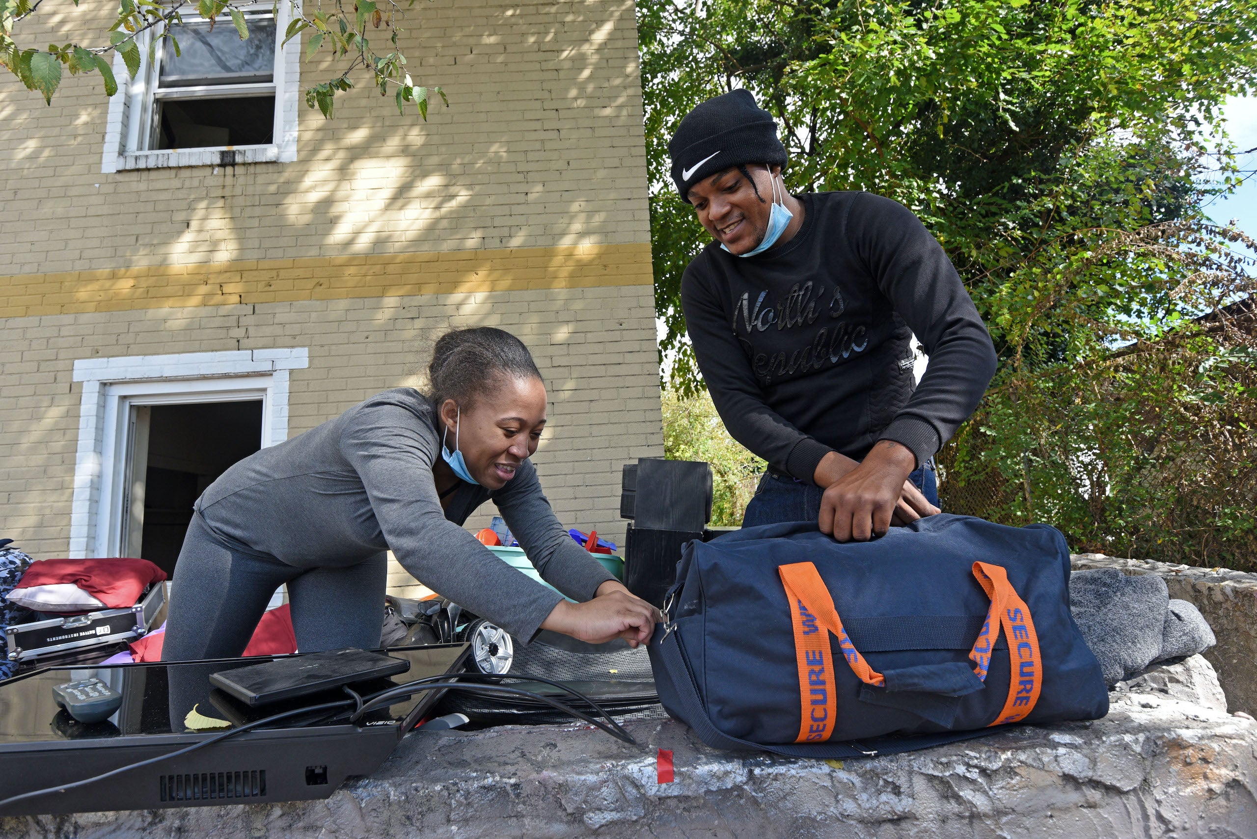 Dehna Morris and Elton Mundle remove belongings from their apartment