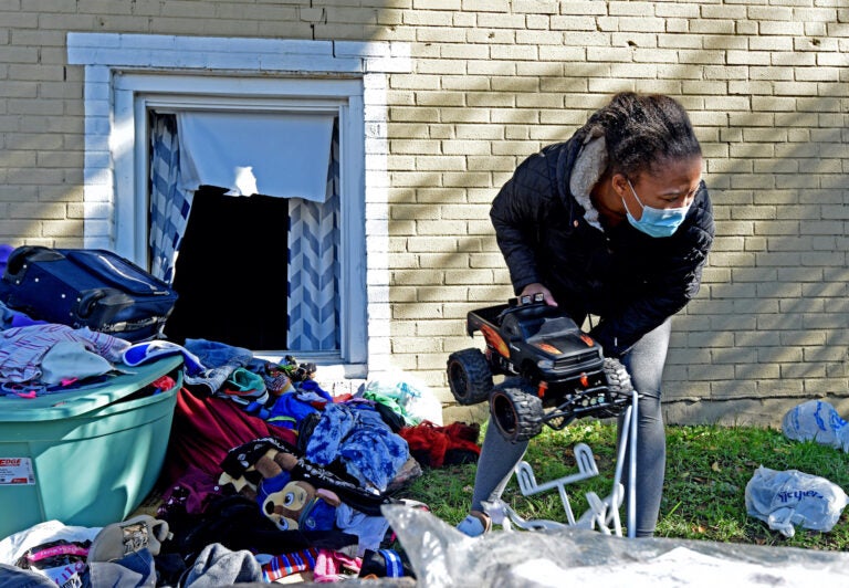 At the Cra-West Apartments in Camden on Oct. 27, tenant Dehna Morris holds a toy that belongs to her 4-year-old son after a three-alarm fire at the complex forced them out.