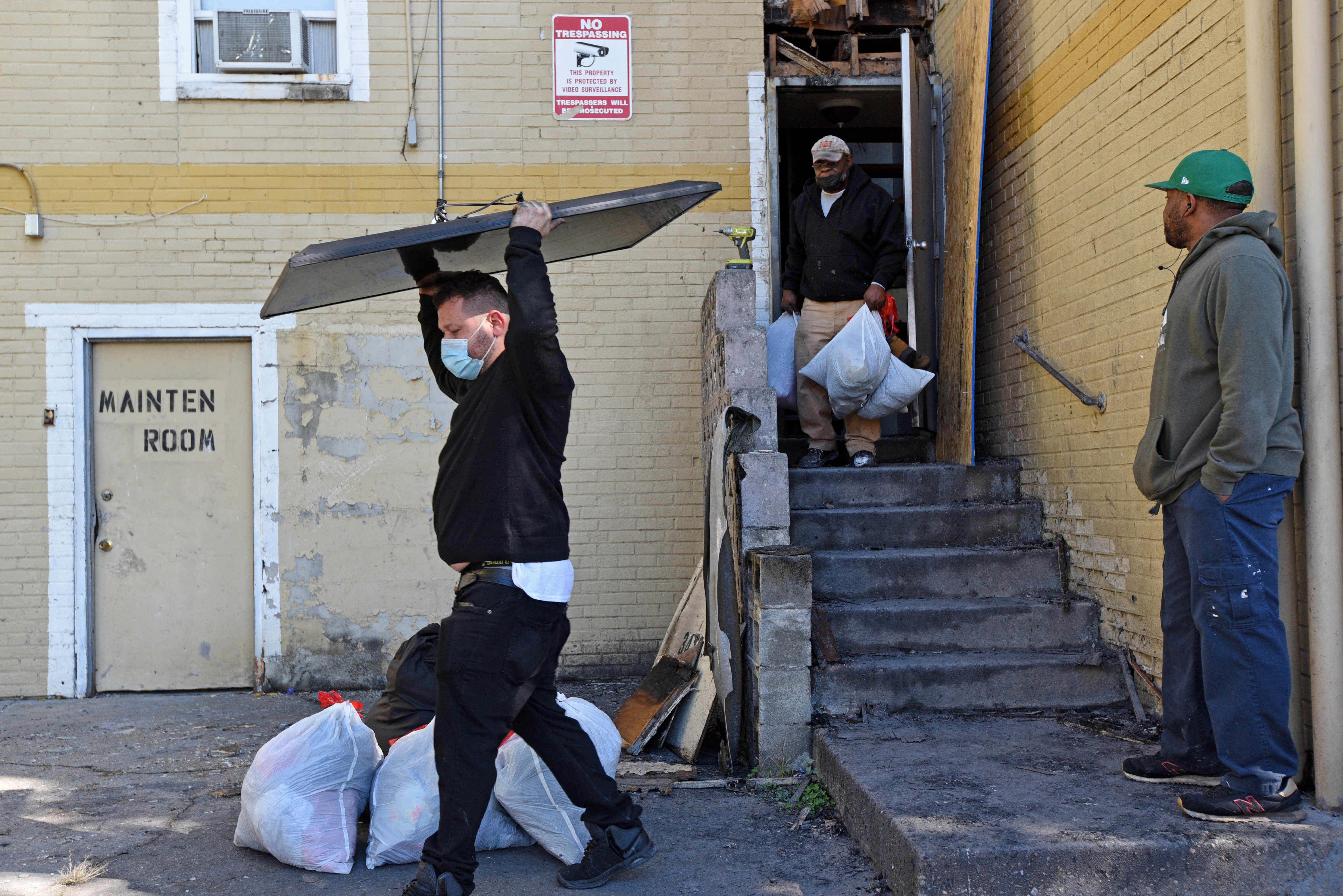 Tenants remove belongings from their apartments