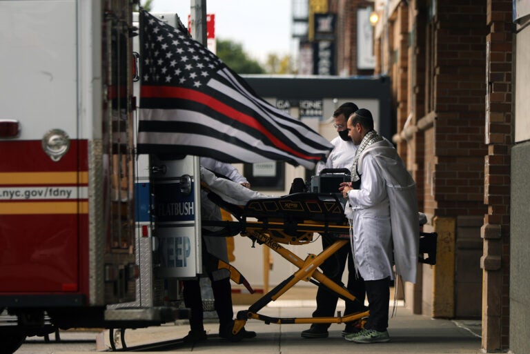 A gurney is wheeled into an ambulance in New York