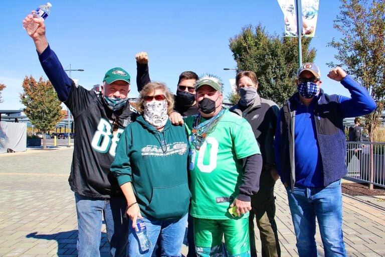 Paul and Sandy Edwards of Quakertown (foreground) and their friends (from left) John Fullerton, Jeff Morris, Tom Cooley, and Mark Lubenetski, arrive at the Linc to watch the first Eagles game of the season that is open to live fans