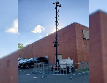 A surveillance camera is visible outside of a building.